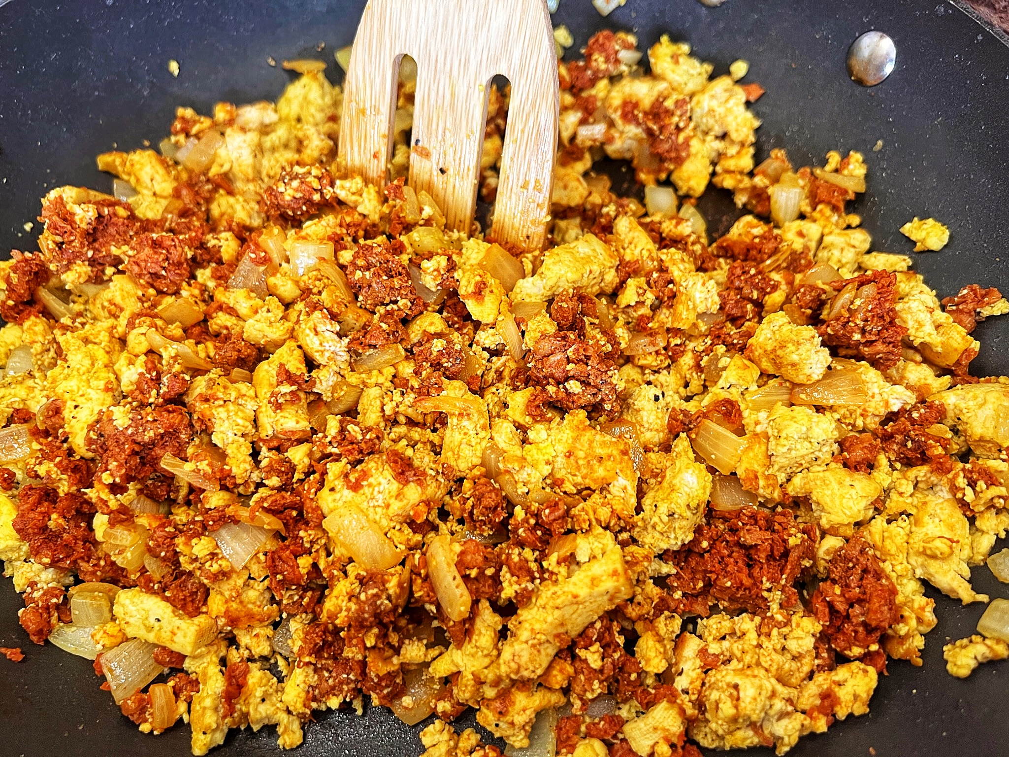 Tofu scramble cooking in pan